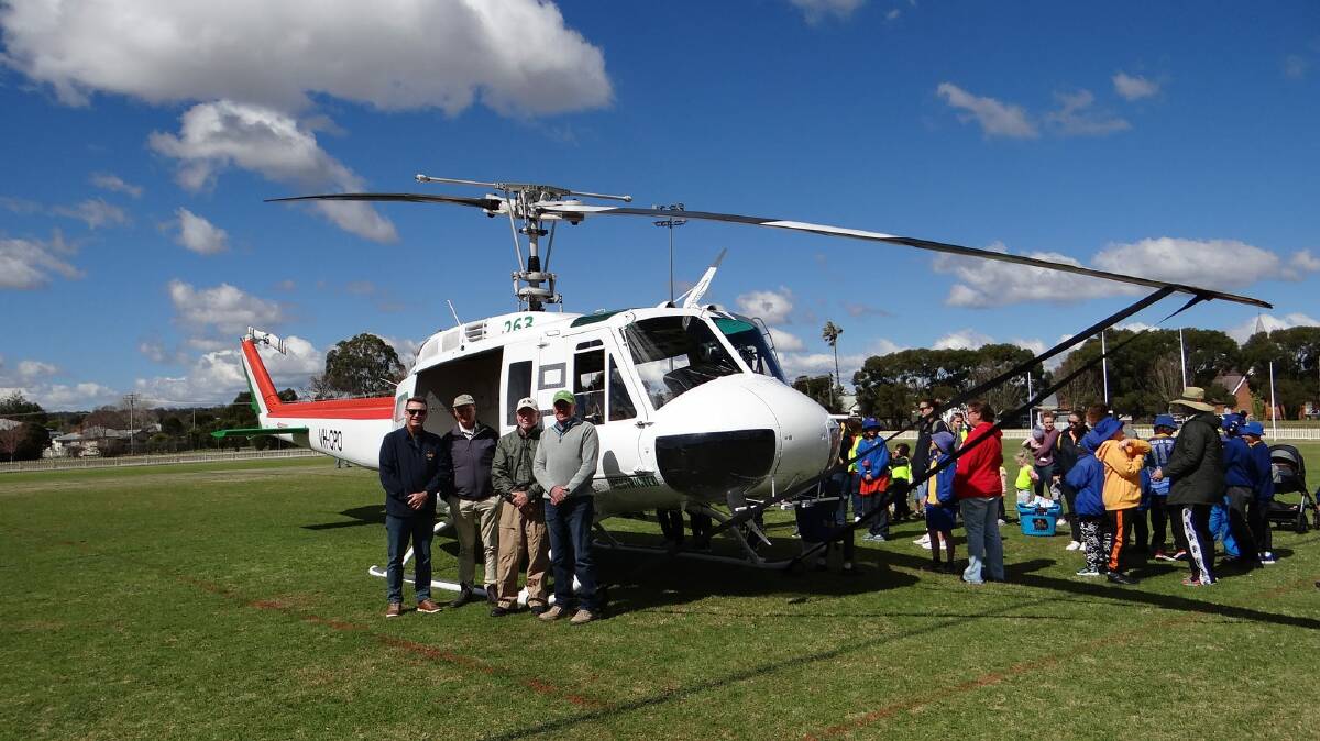 Members of the Inverell RSM Sub Branch with the Bell UH-1H Iroquois Helicopter on Varley Oval at Inverell. Picture supplied.